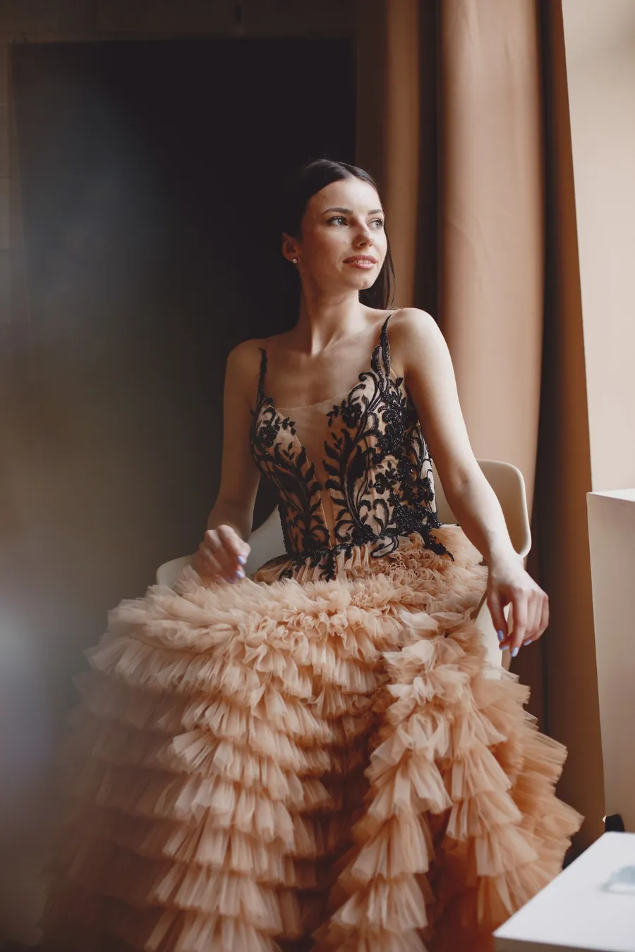 Peach ruffled tulle evening gown with a black lace bodice
